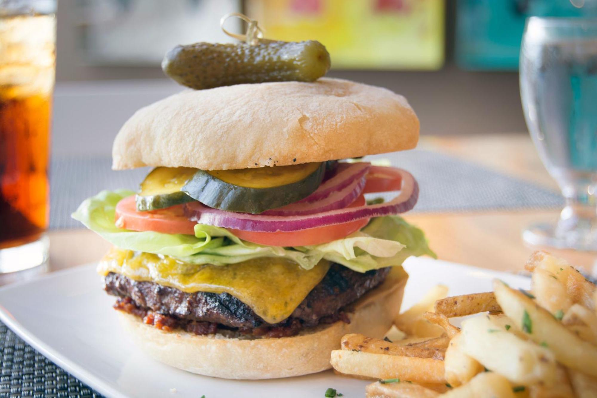 Hotel Murano Tacoma Exteriér fotografie A cheeseburger with lettuce, tomato, onion, and pickle